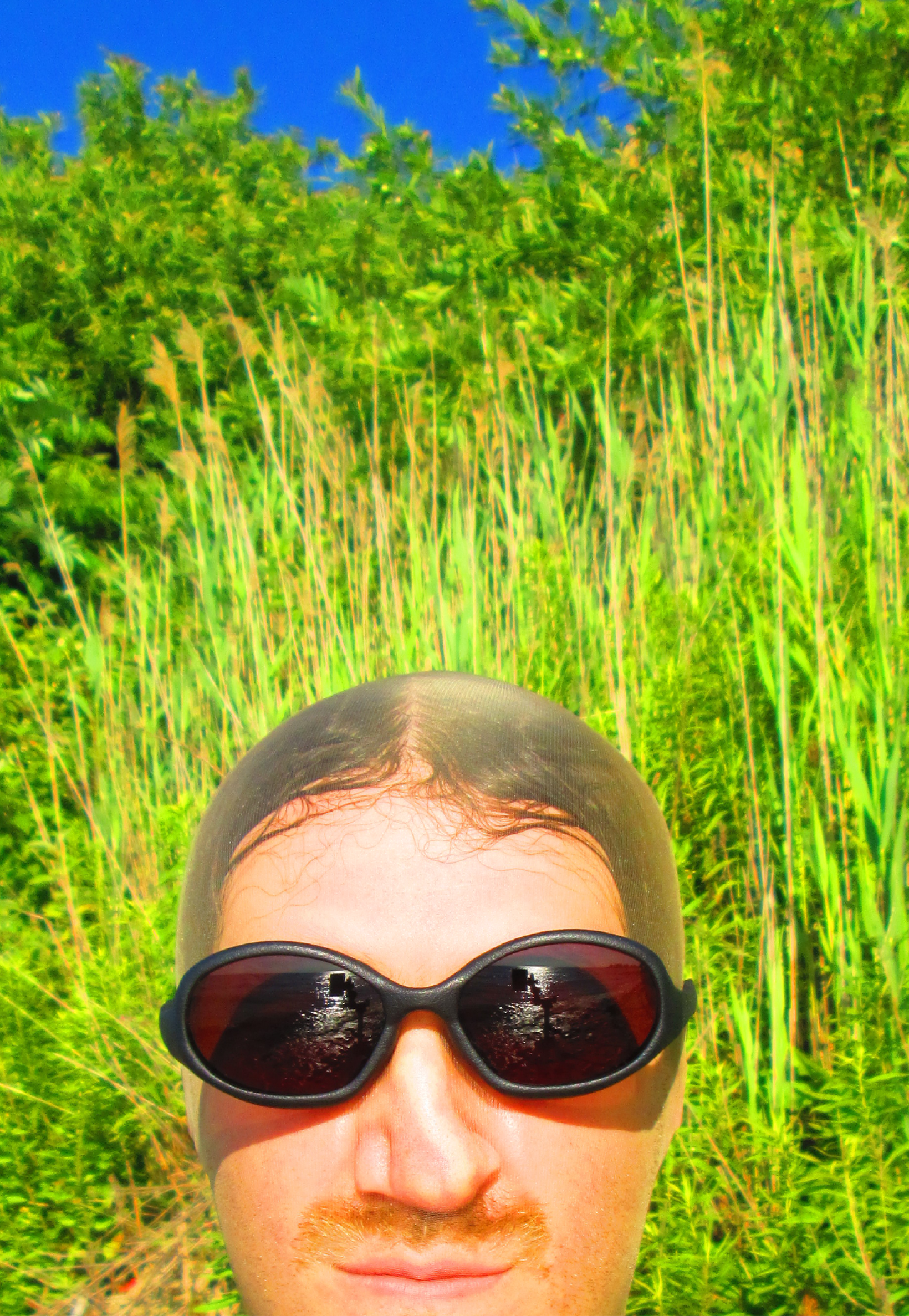 3D render of a bald model wearing black sunglasses with transparent grey lenses