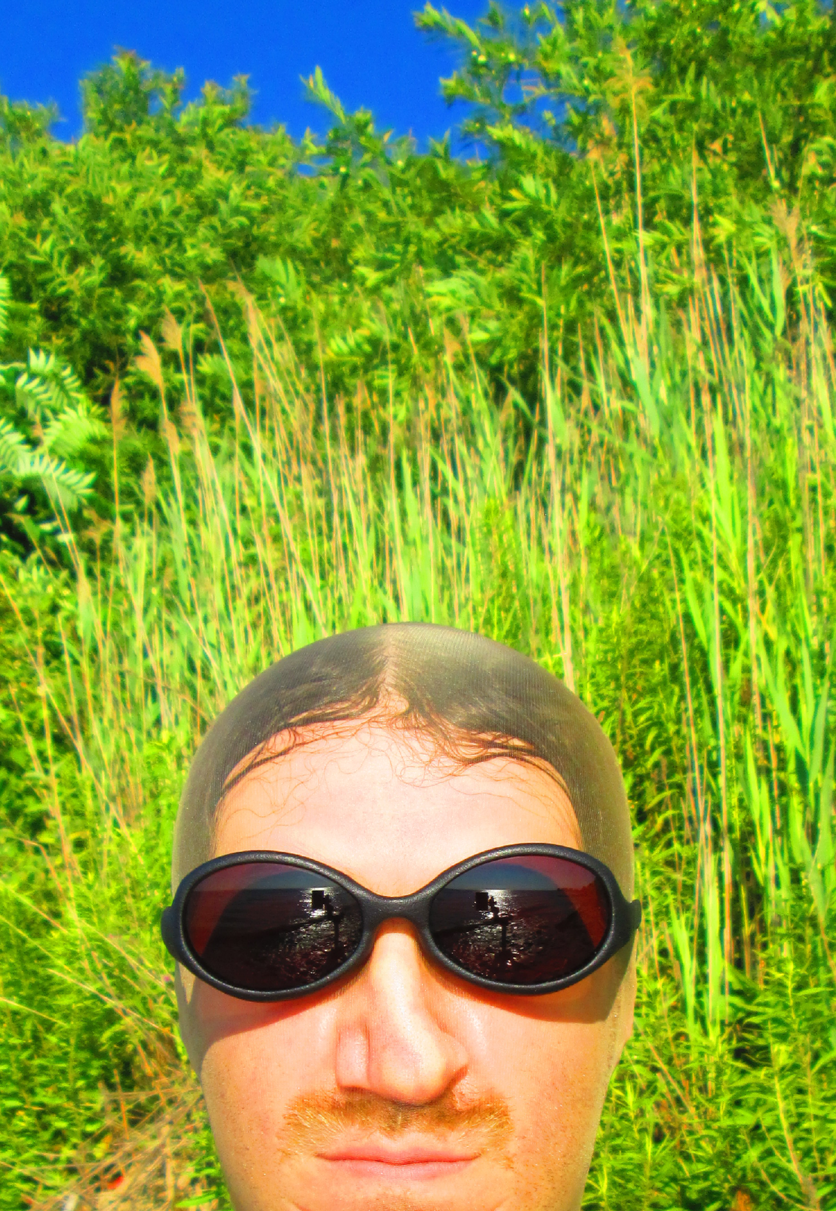 3D render of a bald model wearing black sunglasses with transparent grey lenses